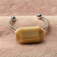 a ring with a beige stone on it